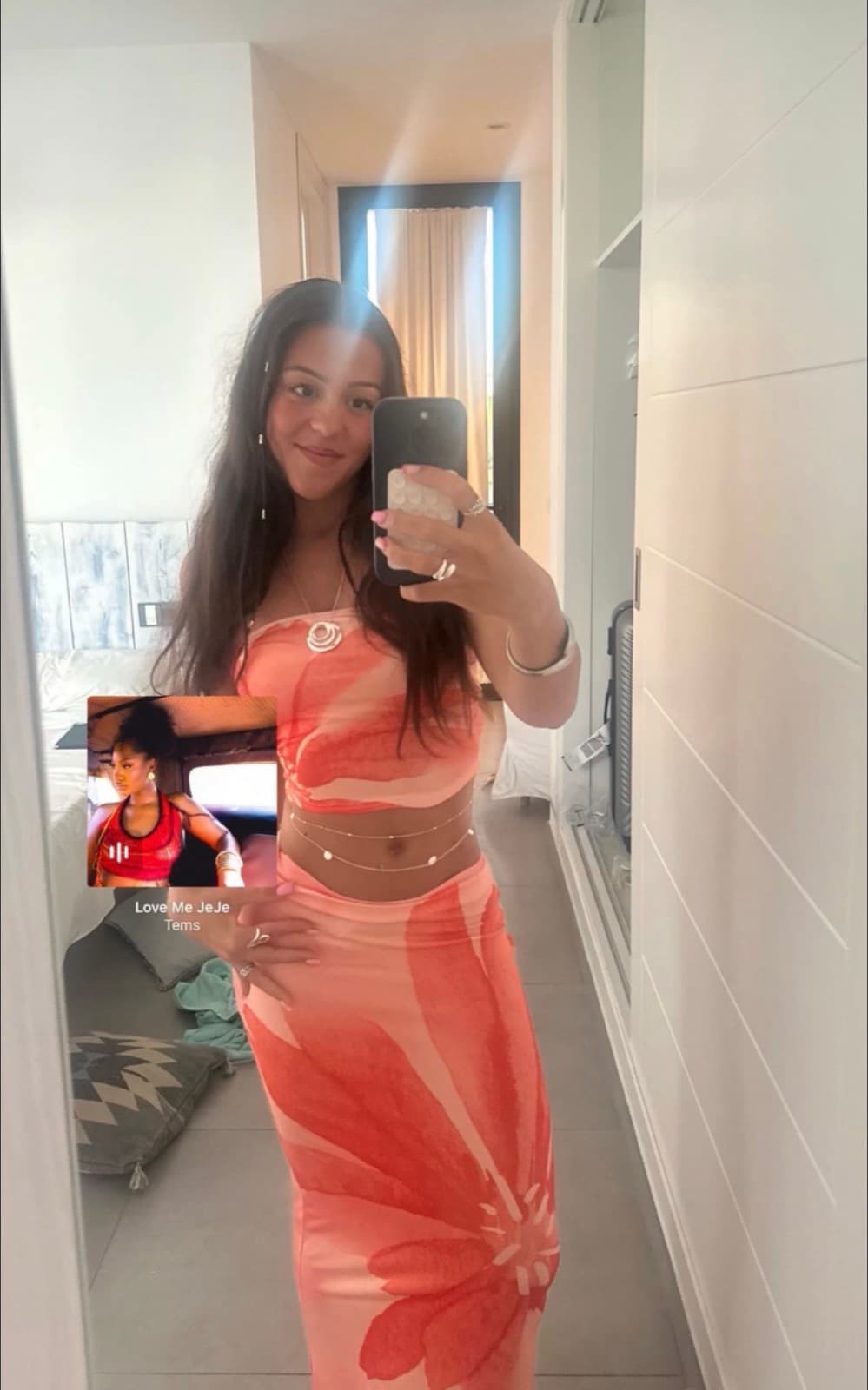 Daisy in an orange floral two-piece, mirror selfie