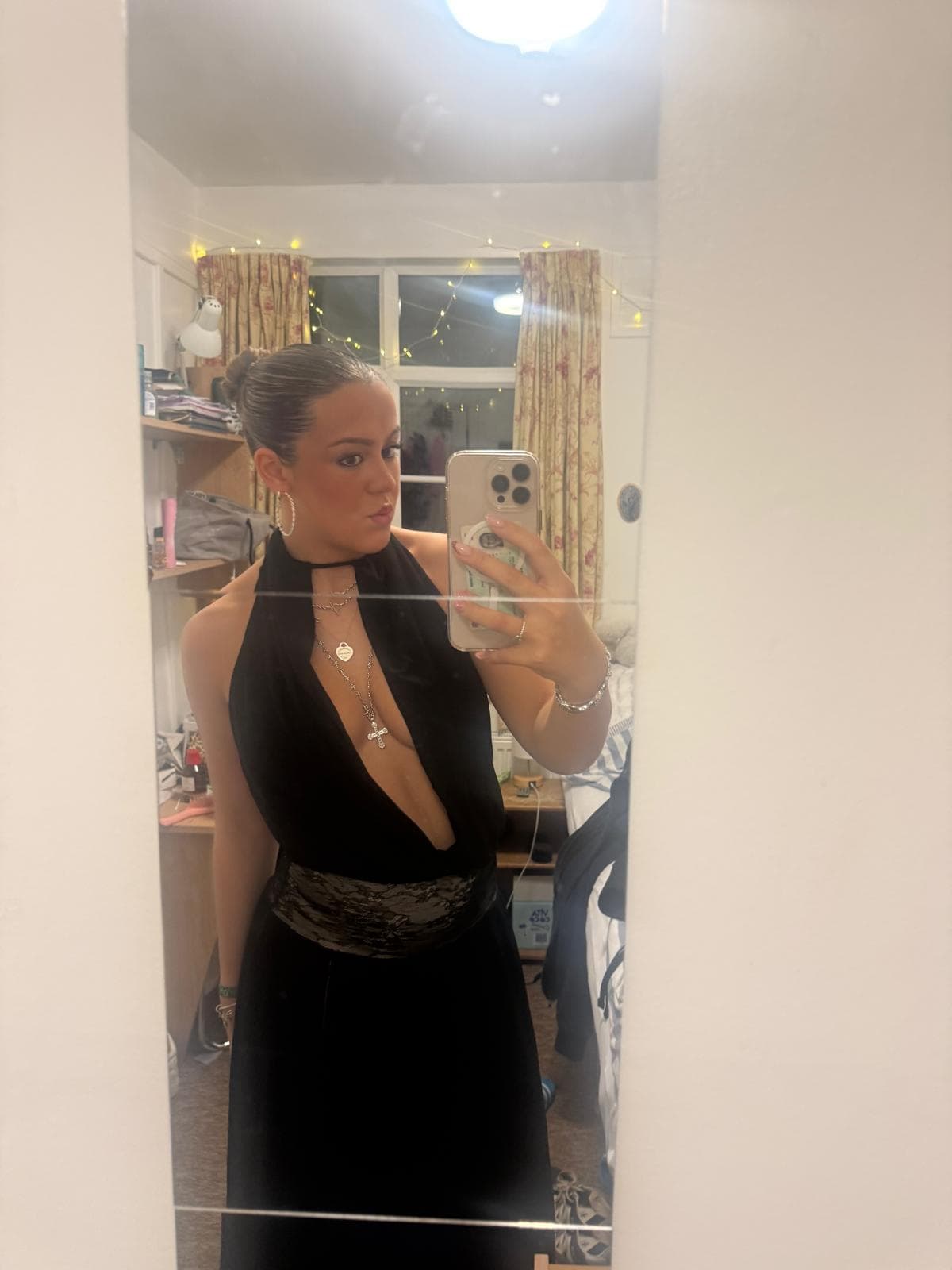 Daisy in a black halterneck dress, mirror selfie